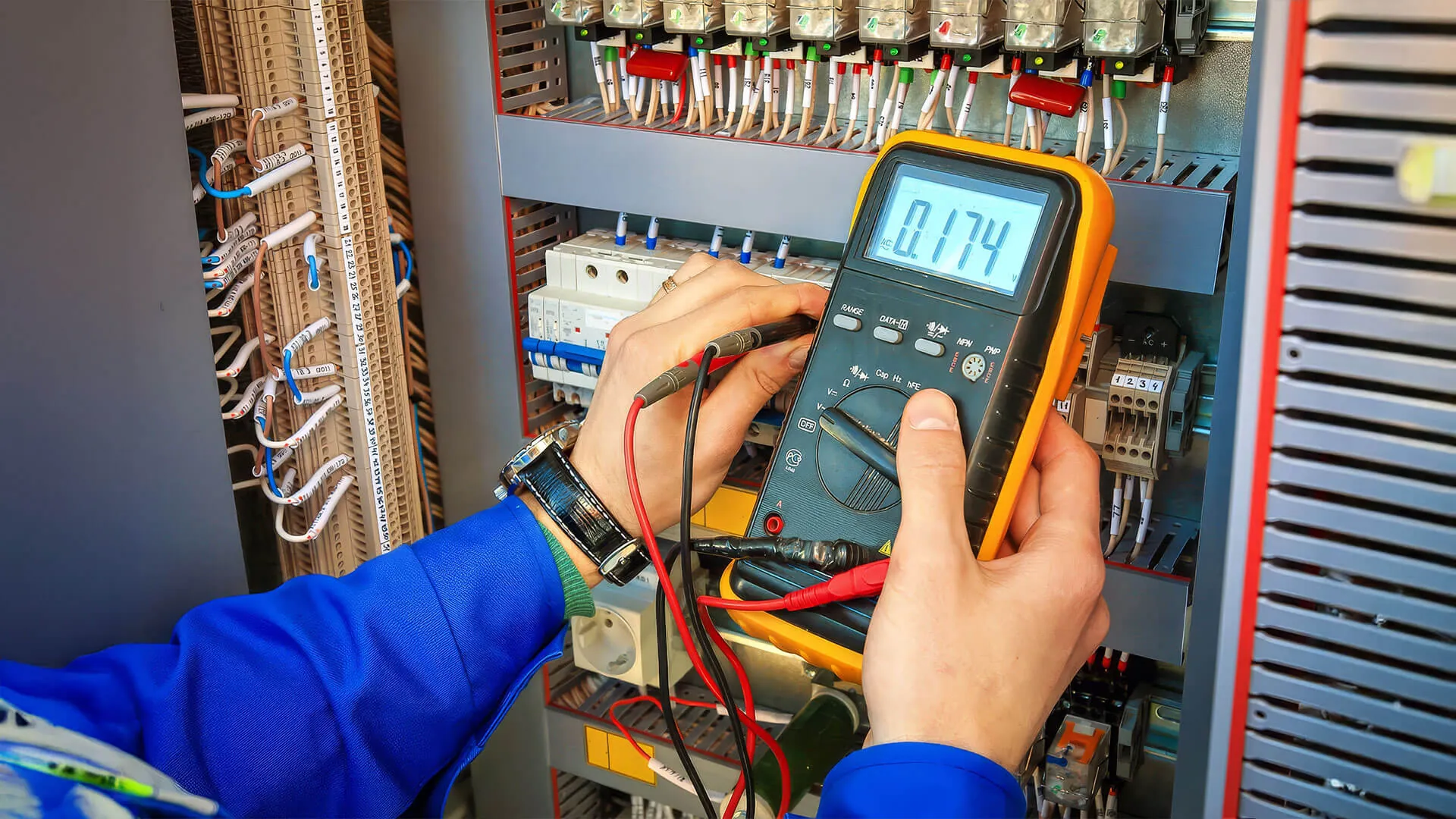 Emergency electrician working on a Brisbane switchboard after hours