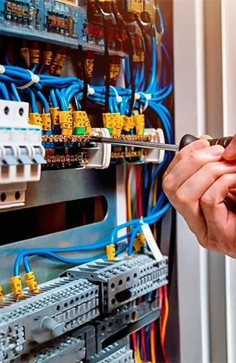 Electrician terminating circuits into a new Brisbane switchboard